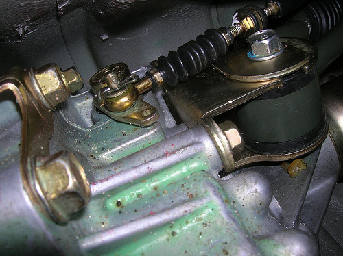 Short Shifter: The bolt that needs to be removed is the one going through the rubber bushing shown in the upper right of this picture.