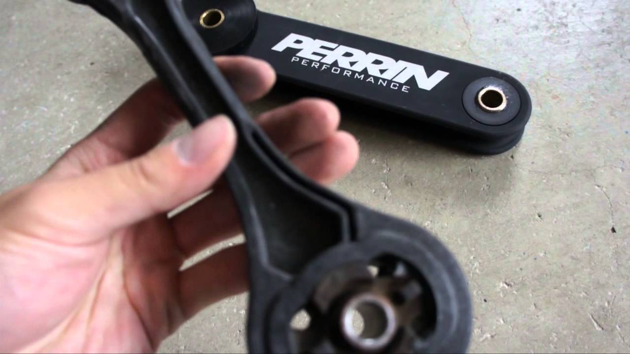 Pitch Stop Mount: In the foreground a oem plastic pitch mount and in the background a Perrin Performance pitch stop mount.