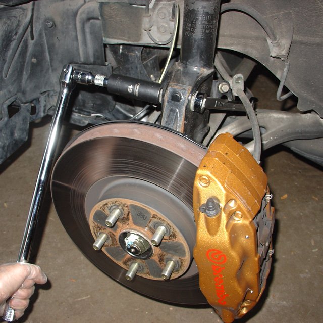 Spring: Throw a wrench on the backside nut to keep the whole thing from spinning.