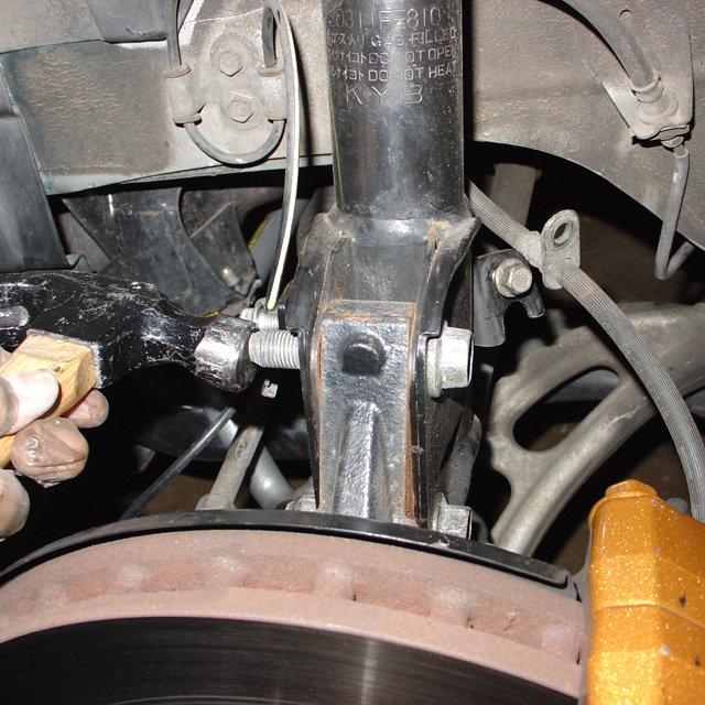 Spring: Once the nut is off you can tap the bolts with a hammer to encourage them to come out.