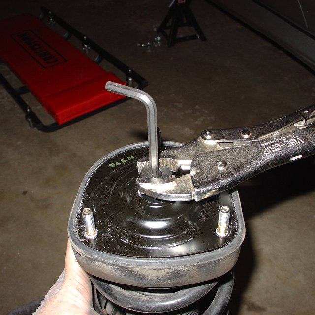 Spring: Go ahead and finish taking off that 17mm top nut.