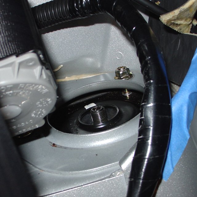 Spring: You'll need to get the 12mm tophat nuts on to hold them in place. This is the part where a second set of hands is most useful. It is hard to hold the struts in place and thread the nuts on at the same time