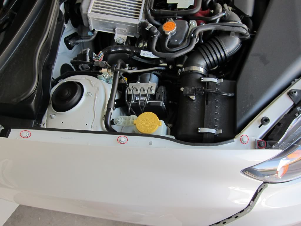 Fender removal Subaru STi GR: Now remove the 3 bolts in the engine bay and the one retaining clip on the headlight fixture.