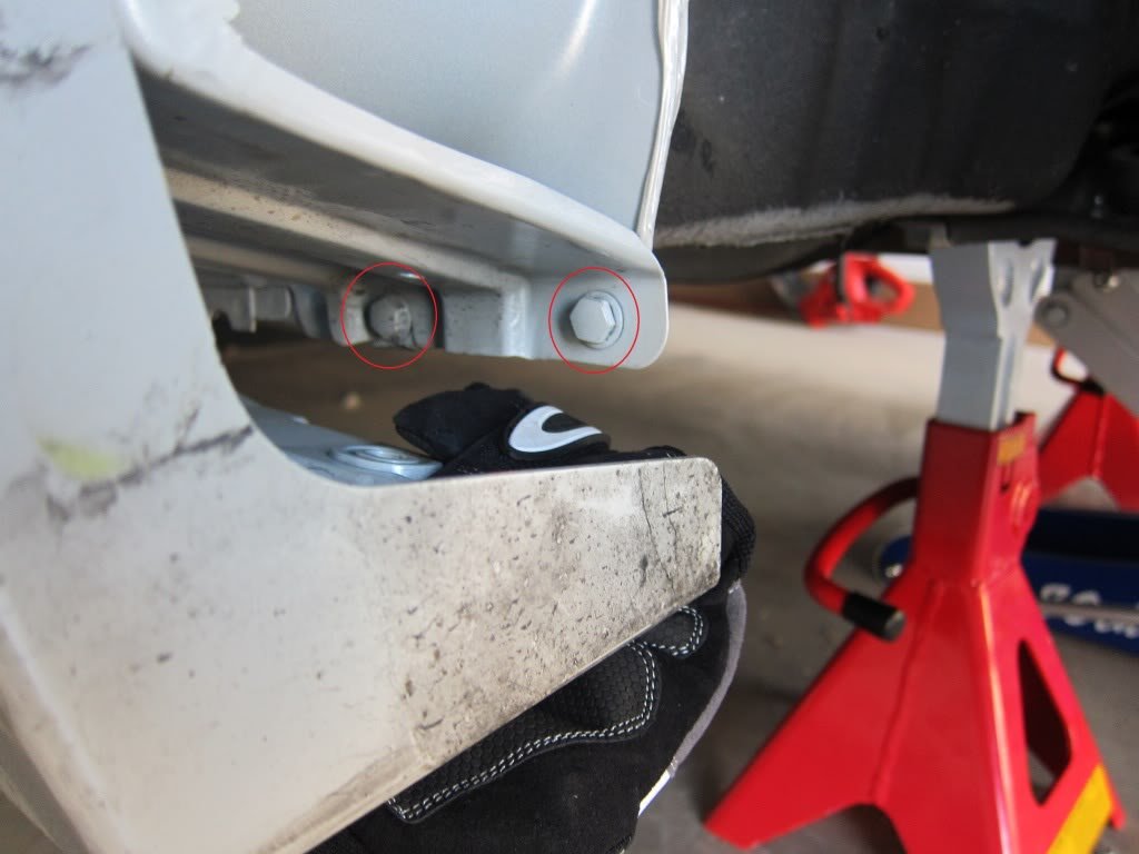 There are two bolts under the side trim. This is where removing the 3rd retaining clip from under neath the side trim gives you a bit more wiggle room.