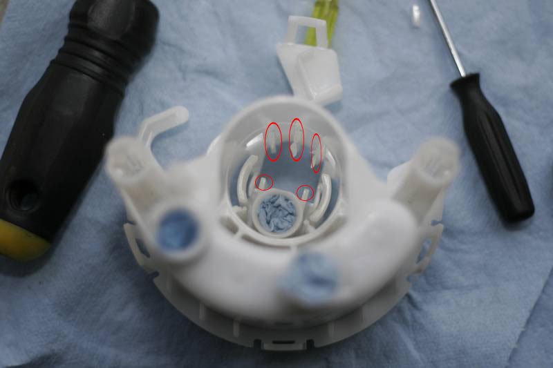 Fuel Pump: ou must shave all 5 of the spots down as far as possible so the walbro can slide in far enough to allow the whole assembly to fit up snug. I recommend using a pair of dykes first to snip off the big pieces, then use a dremel to smooth it all out.