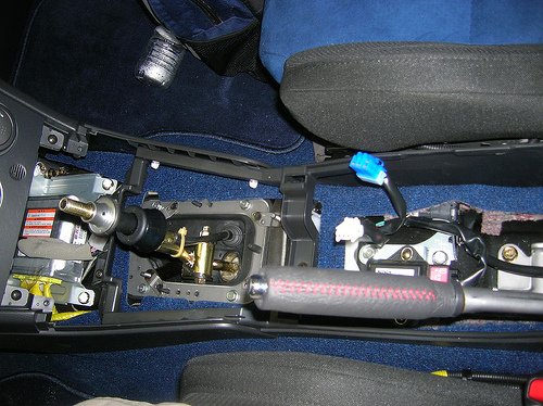 Short shifter: Next there are 4 Phillips screws that need to come out to remove the rest of the console. You will need to unplug the Cig lighter, and the DCCD controls before you can take these pieces out.