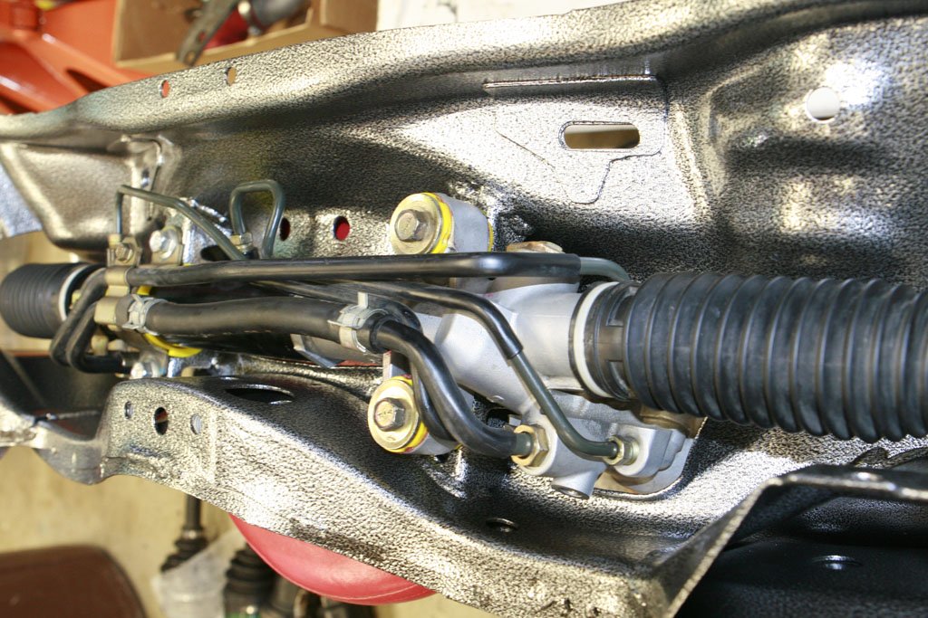 ATF power steering fluid: The rubber hoses in the middle are the ones to drain from.