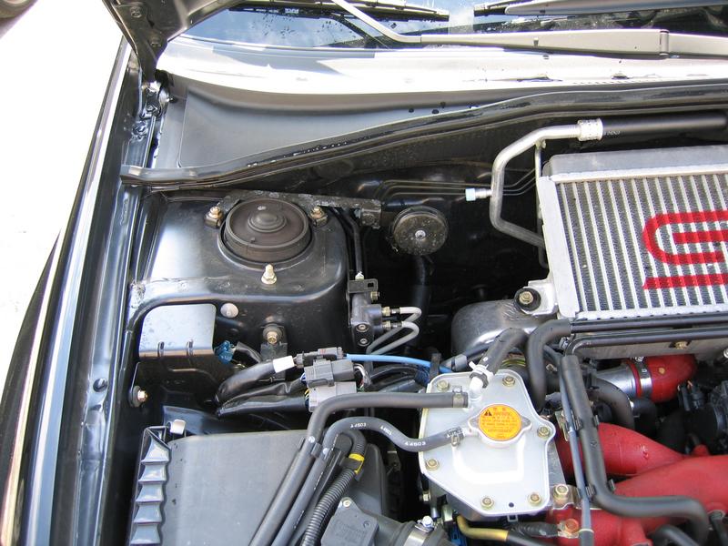 Strut tower brace: Removing the alarm horn bracket. Some models did not come with the alarm horn option so you do not need to do this.