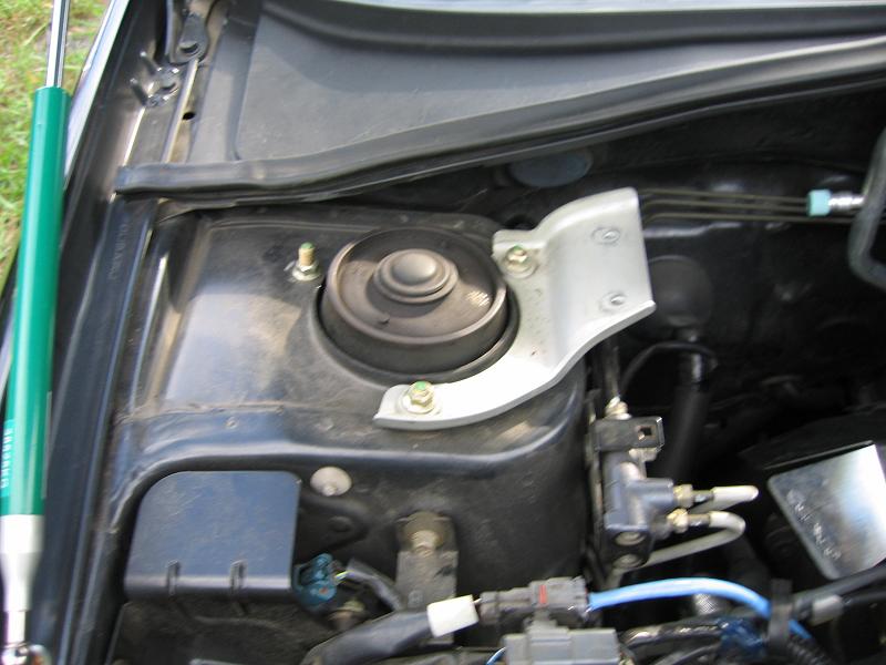 Strut tower brace: Passenger side strut bar end installed.