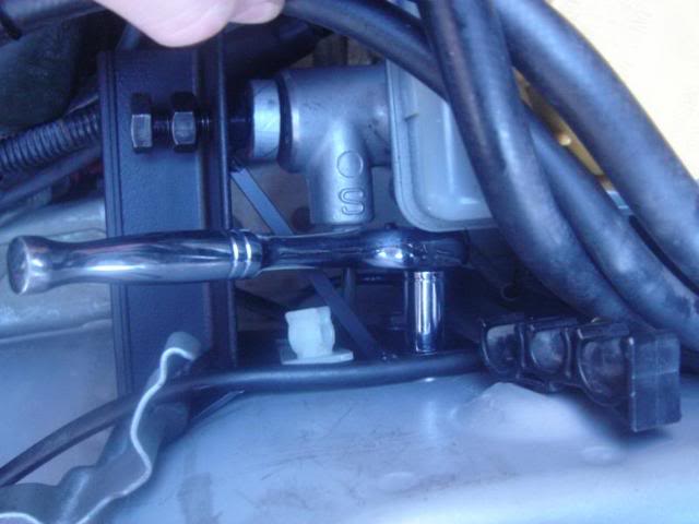 Master Cylinder Brace: To tighten the top rear bolt I used a 10mm socket wrench with 1/4" drive and I was able to tighten the top rear bolt by squeezing the wrench in between the master cylinder and the strut tower. 