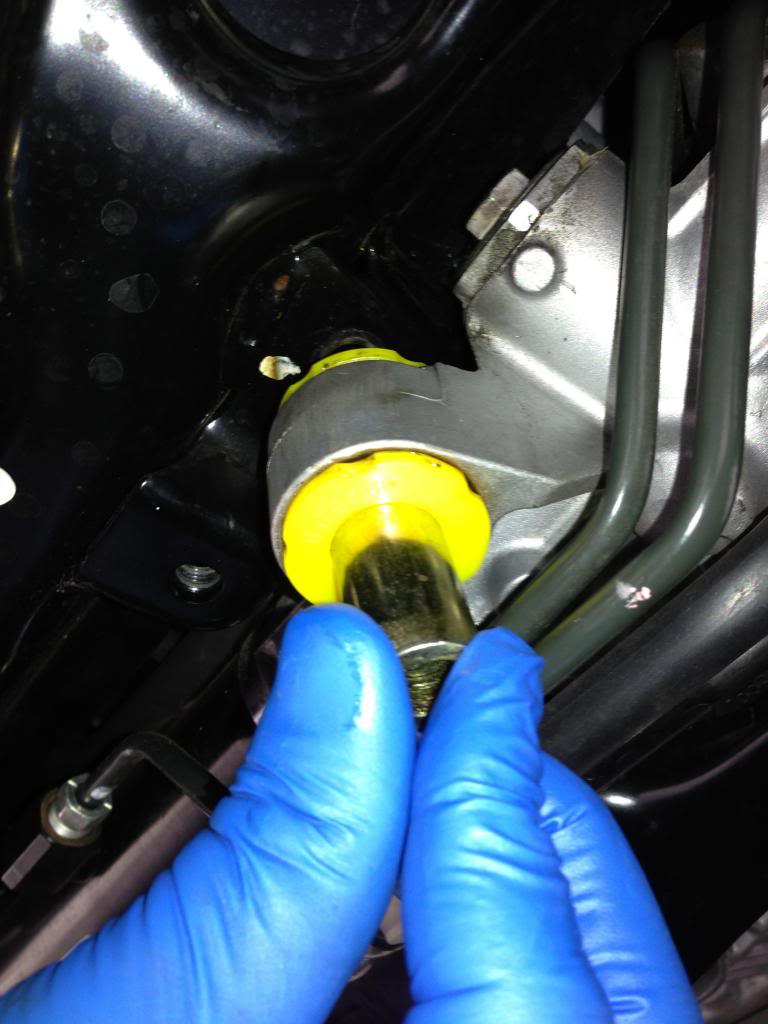 Steering Rack Bushings Install on a 08+ STi: Insert one of the metal sleeves through both halves. Hold the top bushing with your finger tips as you push the metal sleeve through. 